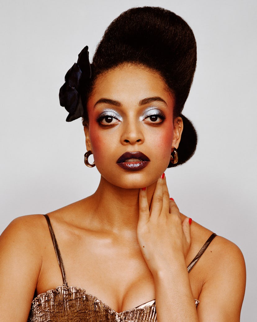 a photo of a woman with silvery eye makeup and dark mauve lips
