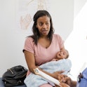 A woman speaks with a nurse at her baby's well-check appointment.