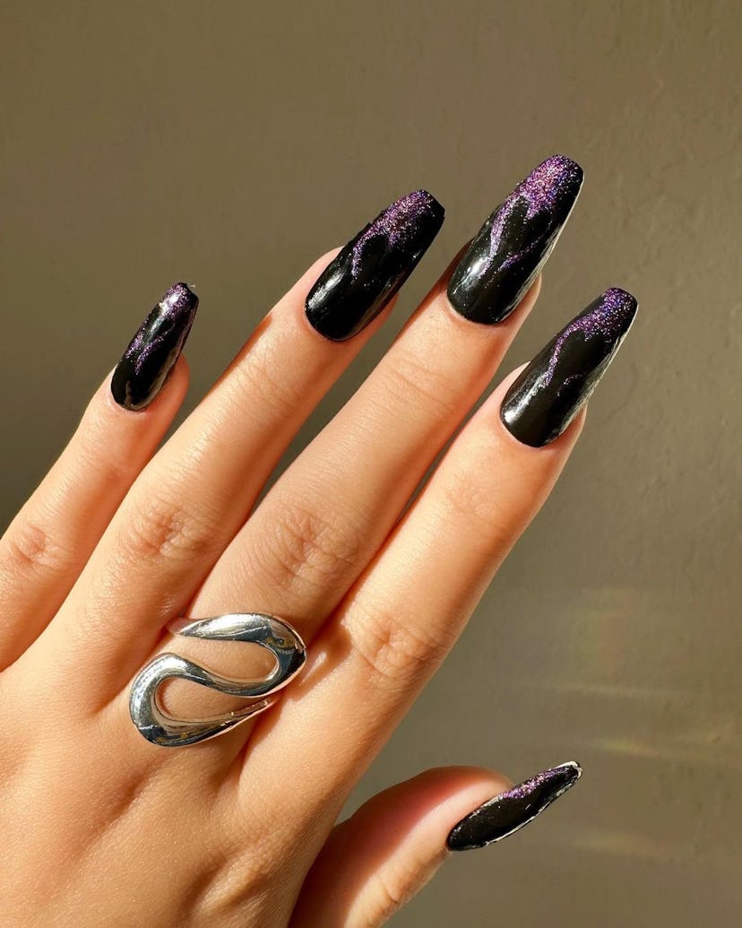 Black and purple galaxy nails.