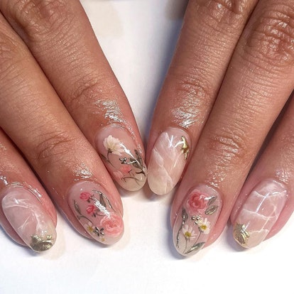 Need a nail art idea for Libra season 2023? Take inspiration from these nude marble nails with flora...