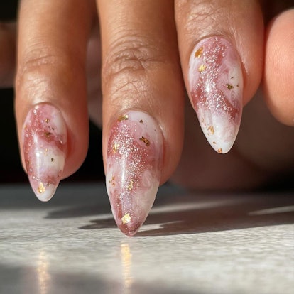 For Libra season 2023, try rose quartz nails with gold flakes.