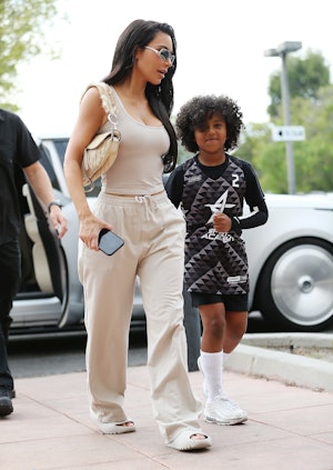 Kim Kardashian carries a Dior Saddle bag.