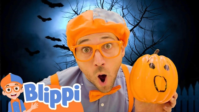 Blippi holding a pumpkin