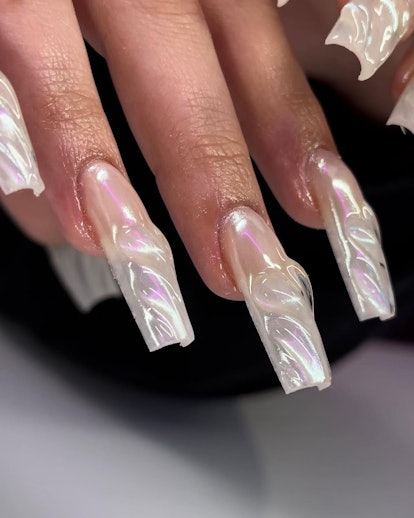 3D nails have been very trendy in 2023. Try a long pearly set of acrylics.