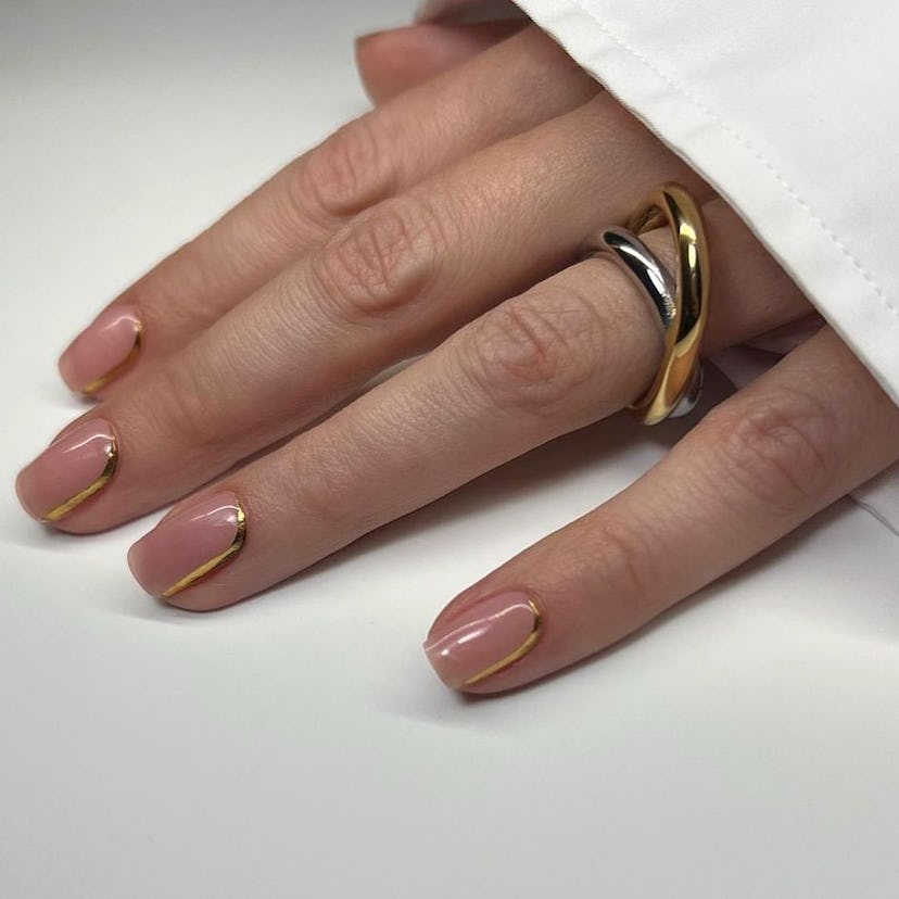 Simple and trendy, subtle gold chrome details on short nails are the perfect nail art design for Lib...