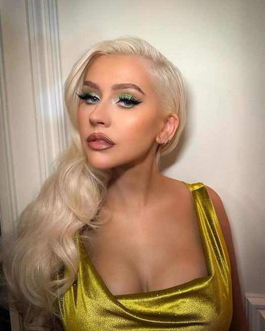Christina Aguilera's martini makeup, created by makeup artist Etienne Ortega, features glittery oliv...