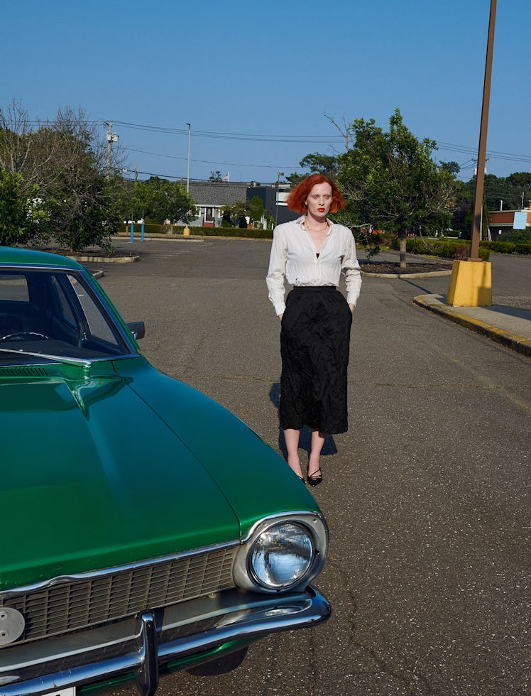 Dior blouse, bralette, skirt, and necklace; Miu Miu shoes.