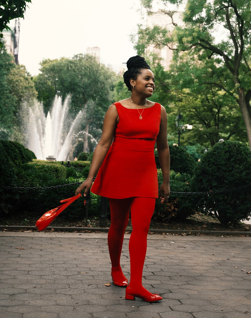An editor wears a monochromatic red outfit, a fall 2023 trend, wearing a red dress, tights, shoes, a…