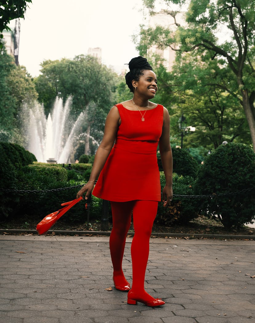 An editor wears a monochromatic red outfit, a fall 2023 trend, wearing a red dress, tights, shoes, a...