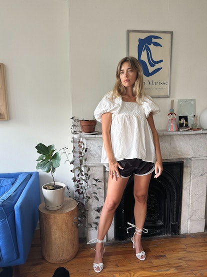 Aemilia Madden wears black Nike tempo shorts and a puff-sleeve top.