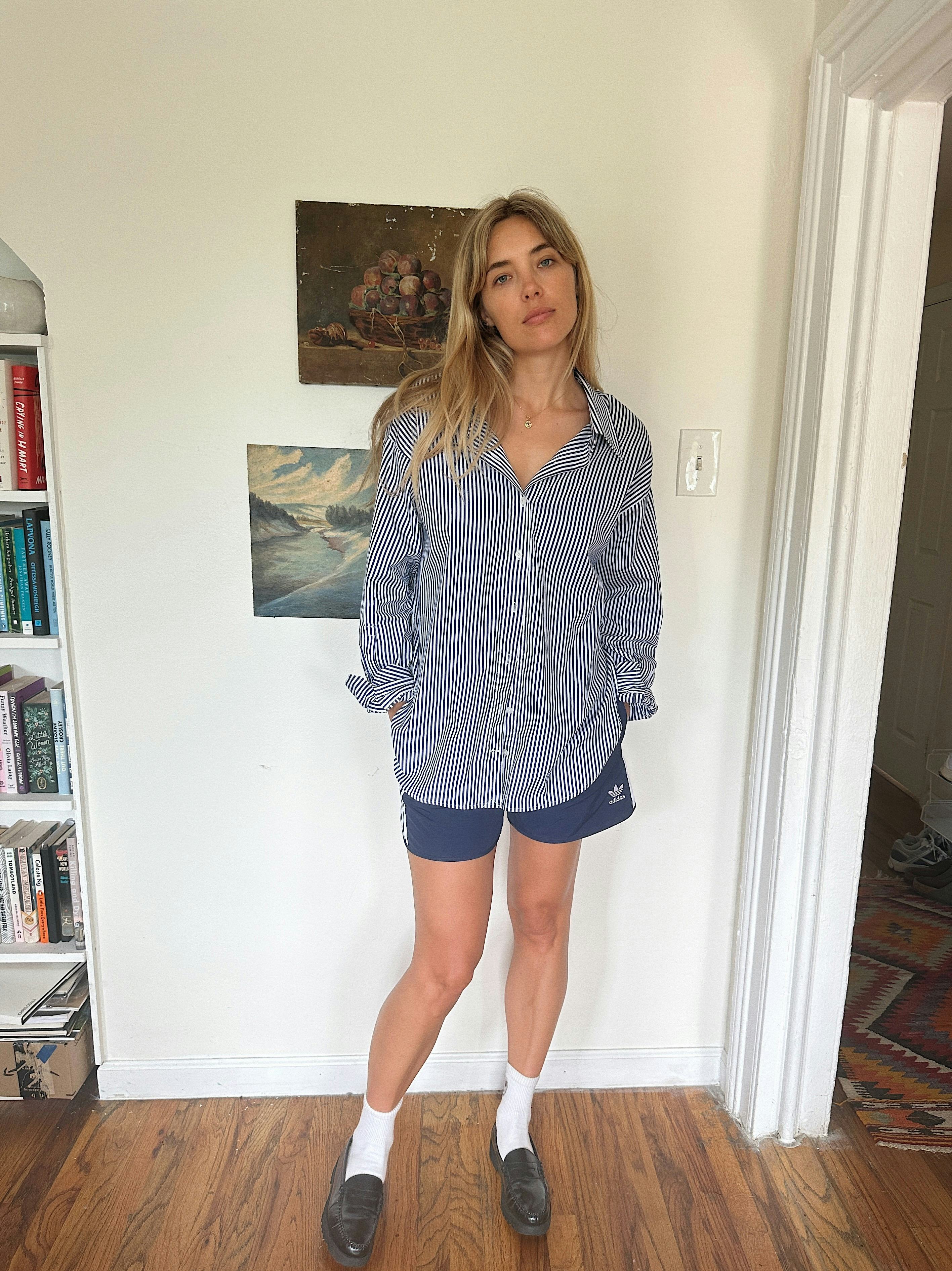 Aemilia Madden wears gym shorts with a striped button-up