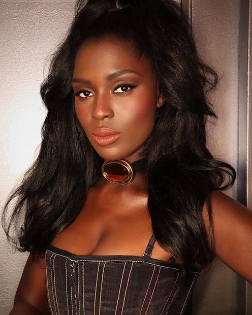 Jodie Turner-Smith long blowout curls and bustier