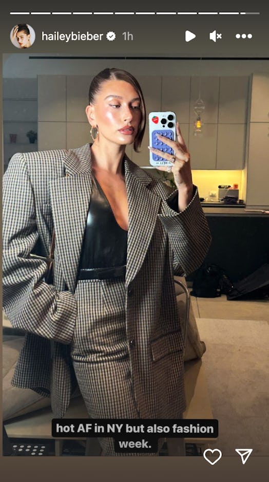 Hailey Bieber wears a Saint Laurent blazer and skirt in a photo posted to her Instagram.