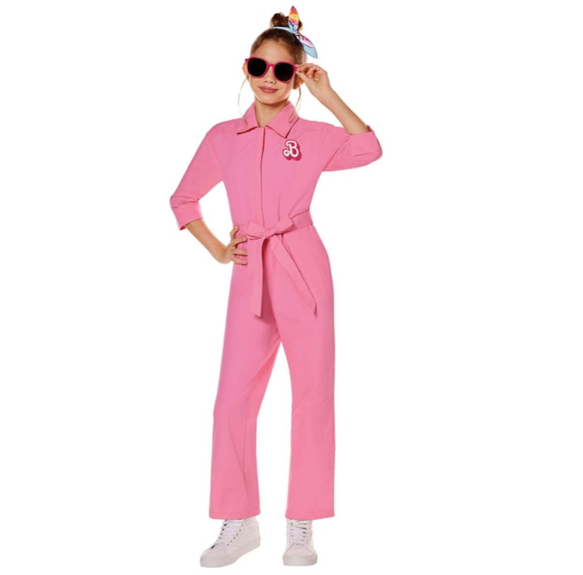 young girl in the pink power suit from Barbie