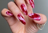 Here are trendy manicure ideas for dark red nails, including chrome, French tips, and more.