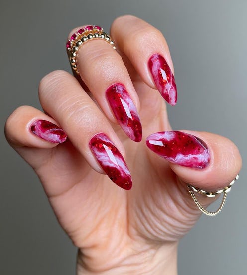 Here are trendy manicure ideas for dark red nails, including chrome, French tips, and more.