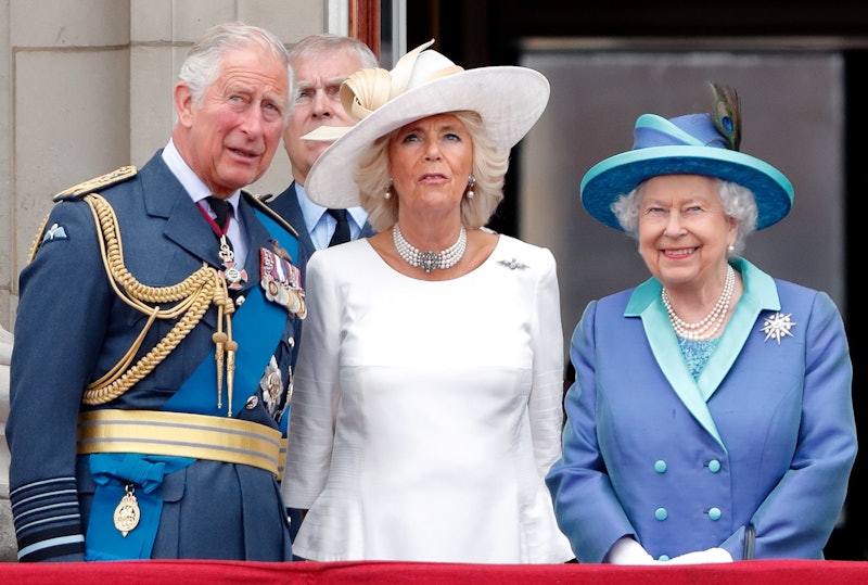 King Charles III, Queen Camilla, and the late Queen Elizabeth II at Buckingham Palace.