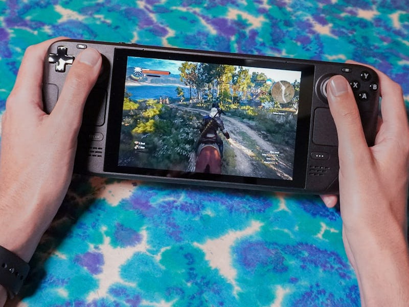 Hands holding Valve's Steam Deck handheld gaming PC.