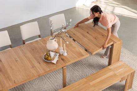 Woman adjusting piece from new Transformer Table 4.0 collection