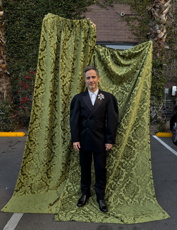 Gael García Bernal wears an Alexander McQueen jacket, shirt, pants, and brooch; Church’s shoes. 