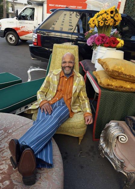 Jeffrey Wright wears a Marni jacket, shirt, turtleneck, and pants; Boss shoes; his own glasses throu...