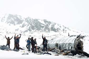 The cast of 'Society of the Snow' stand near the remains of a crashed airplane