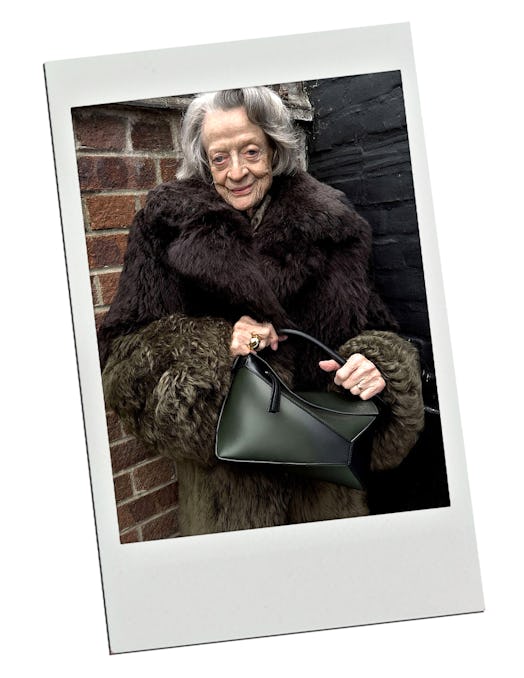 Dame Maggie Smith carries a black Loewe Puzzle bag.