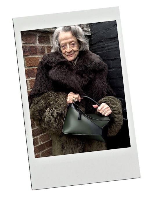 Dame Maggie Smith carries a black Loewe Puzzle bag. 