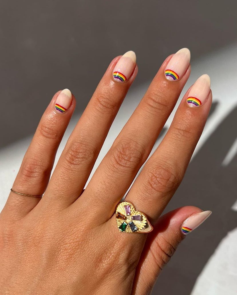 Retro rainbow half moon details on short almond nails are on-trend for 2024.