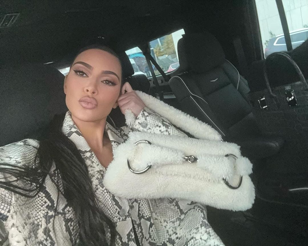 Kim Kardashian carries the Gucci Horsebit Chain in shearling.