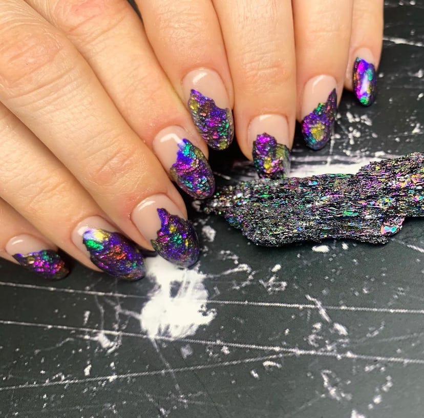 Purple gemstone designs on short almond nails are on-trend for 2024.