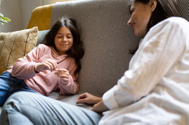 A young girl talks with her mom.