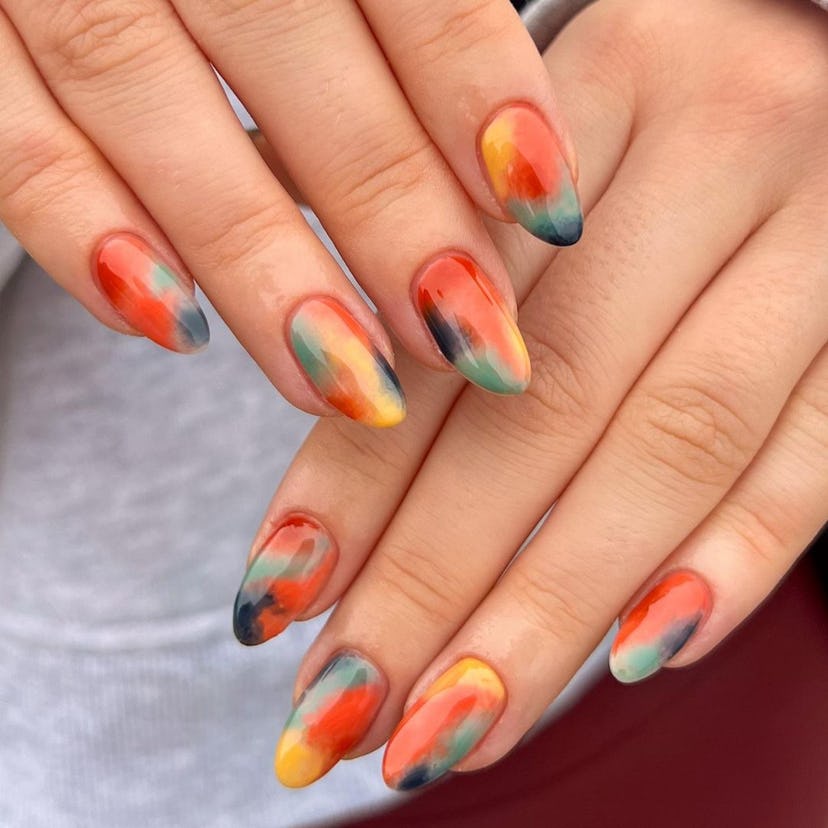 Groovy tie dye art on short almond nails are on-trend for 2024.