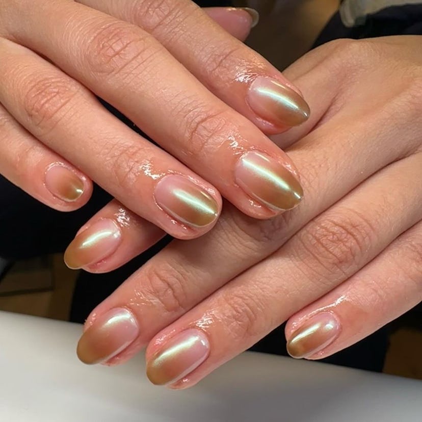 Ombré nails with a chrome finish on short almond nails are on-trend for 2024.