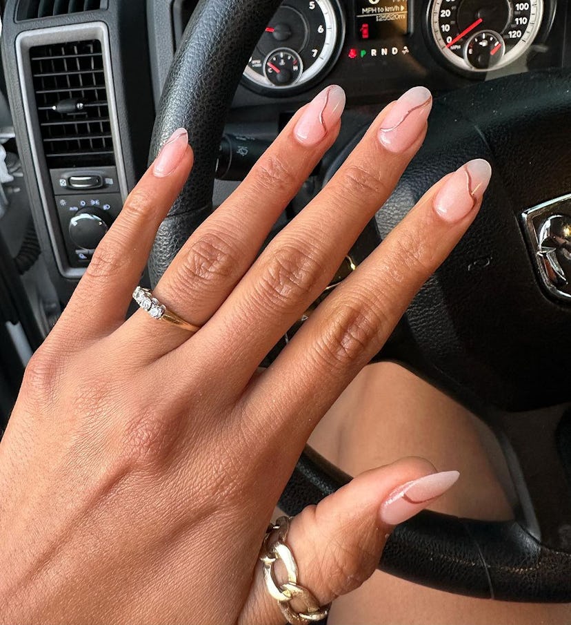 3D rose gold squiggles on short almond nails are on-trend for 2024.