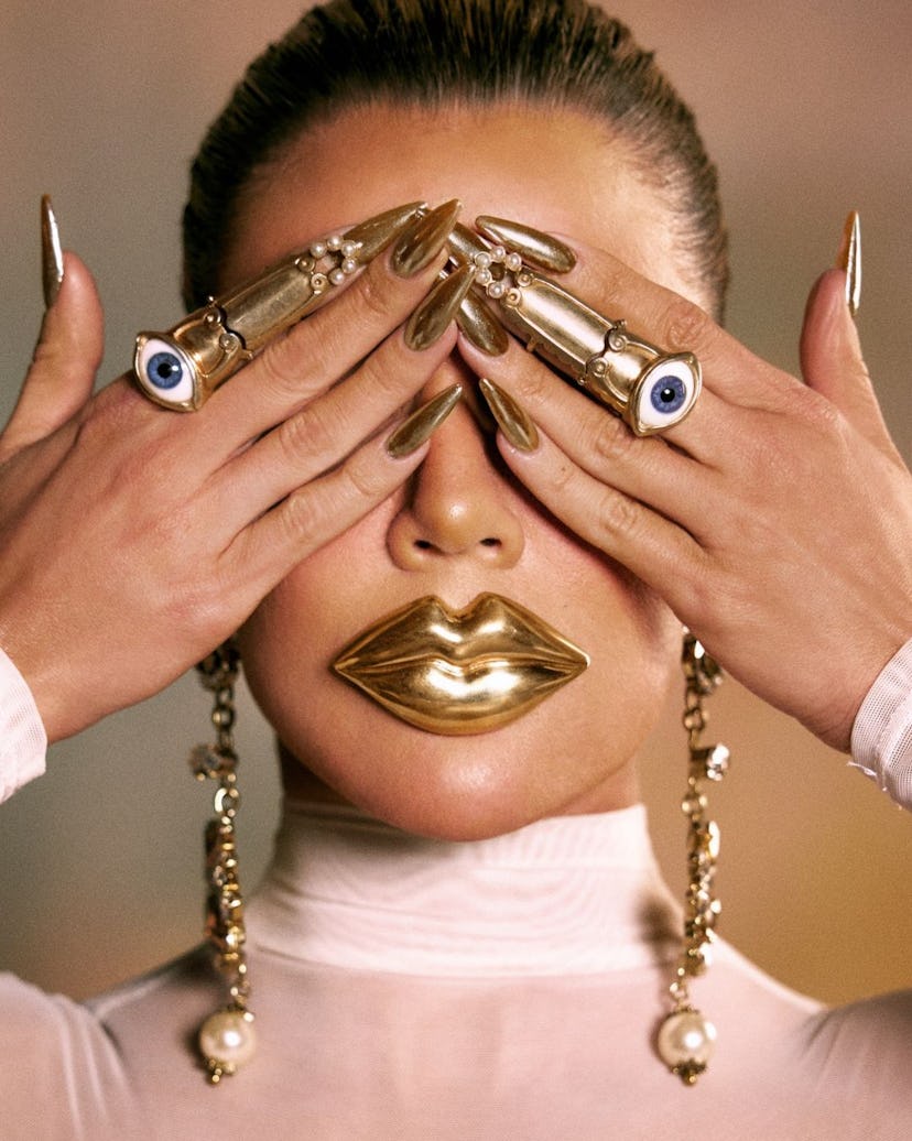 Khloé Kardashian wore gold chrome nails for TMRW Magazine's latest cover.