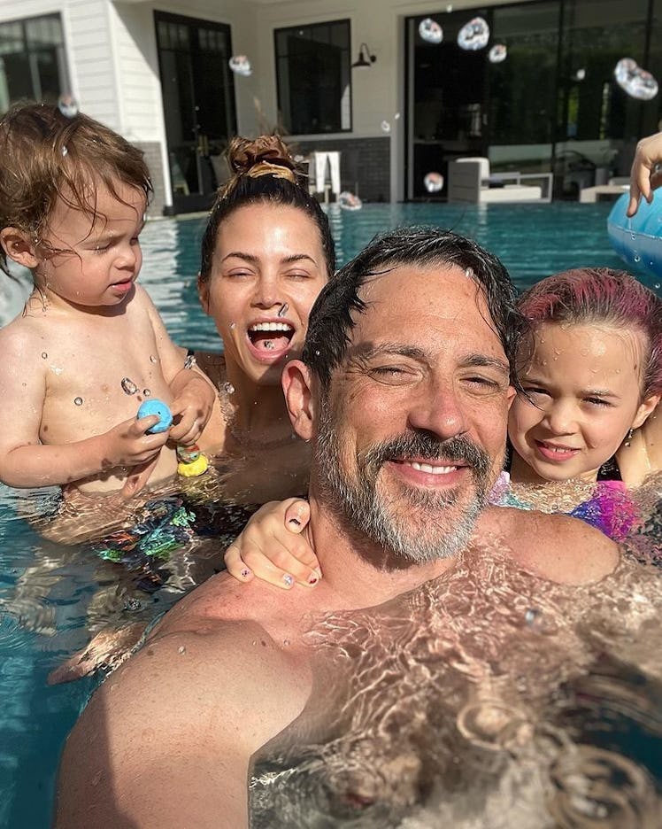 Jenna Dewan and Steve Kazee pose in a swimming pool with their children