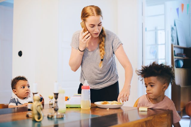 A mom feeds her kids breakfast.