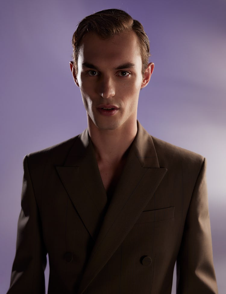 Model Kit Butler wears a brown blazer. 