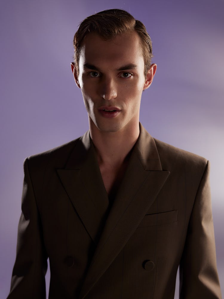 Model Kit Butler wears a brown blazer. 