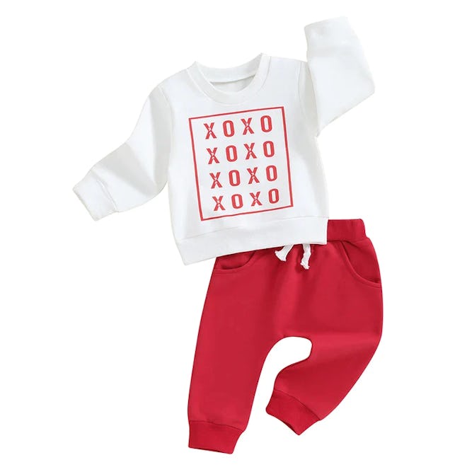 XOXO sweatshirt with red sweatpants, a comfy baby's first valentine's day outfit.