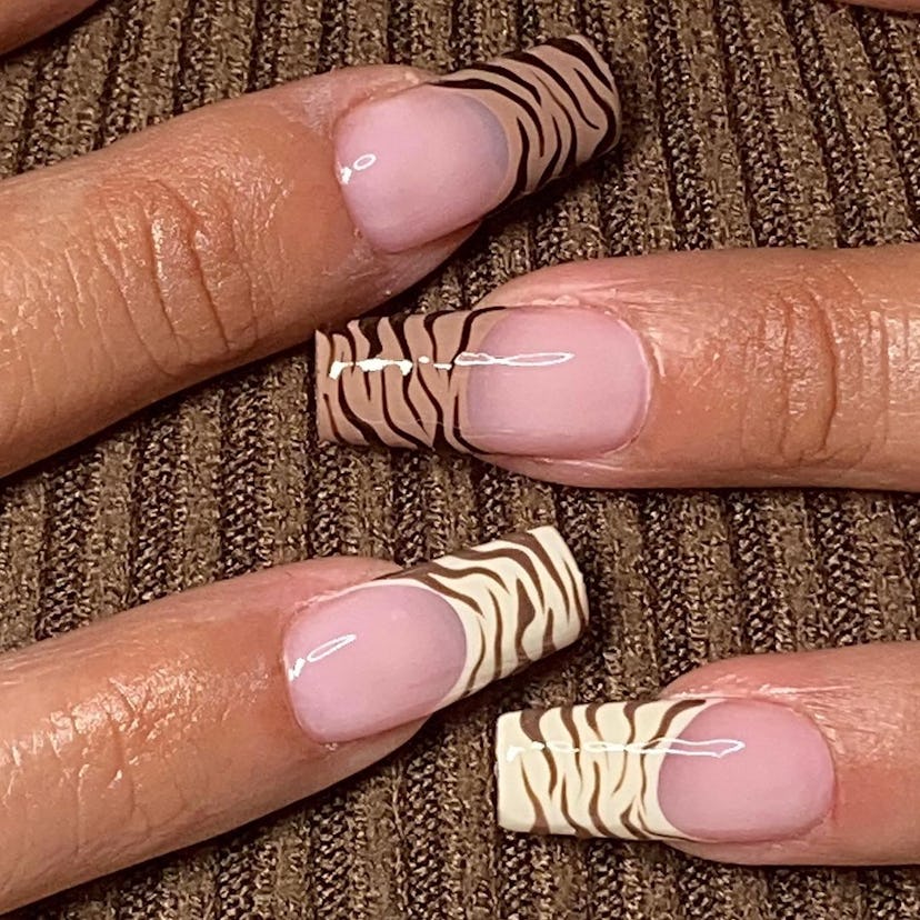 Tonal zebra print French tip nails match the mob wife aesthetic.