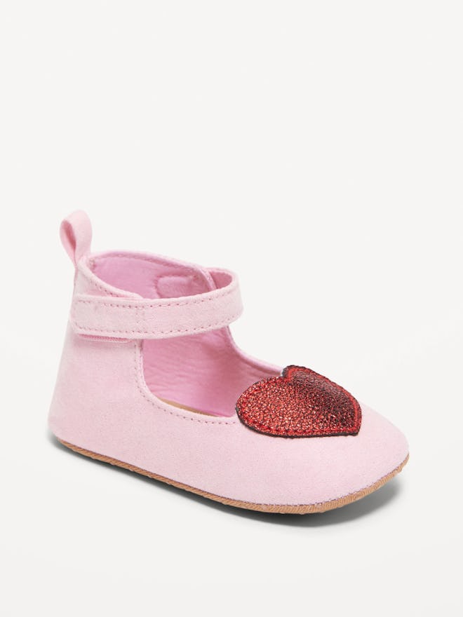 A pink baby shoe with a sparkling red heart, the perfect shoes for baby's first valentine's day outf...