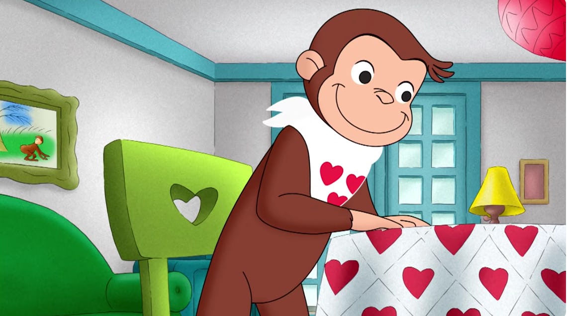 George sits at a table decorated for Valentine's Day.