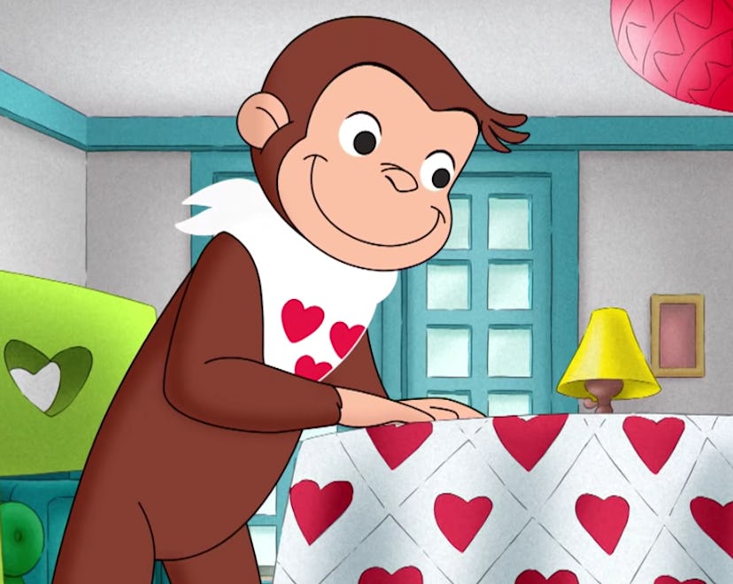 George sits at a table decorated for Valentine's Day.