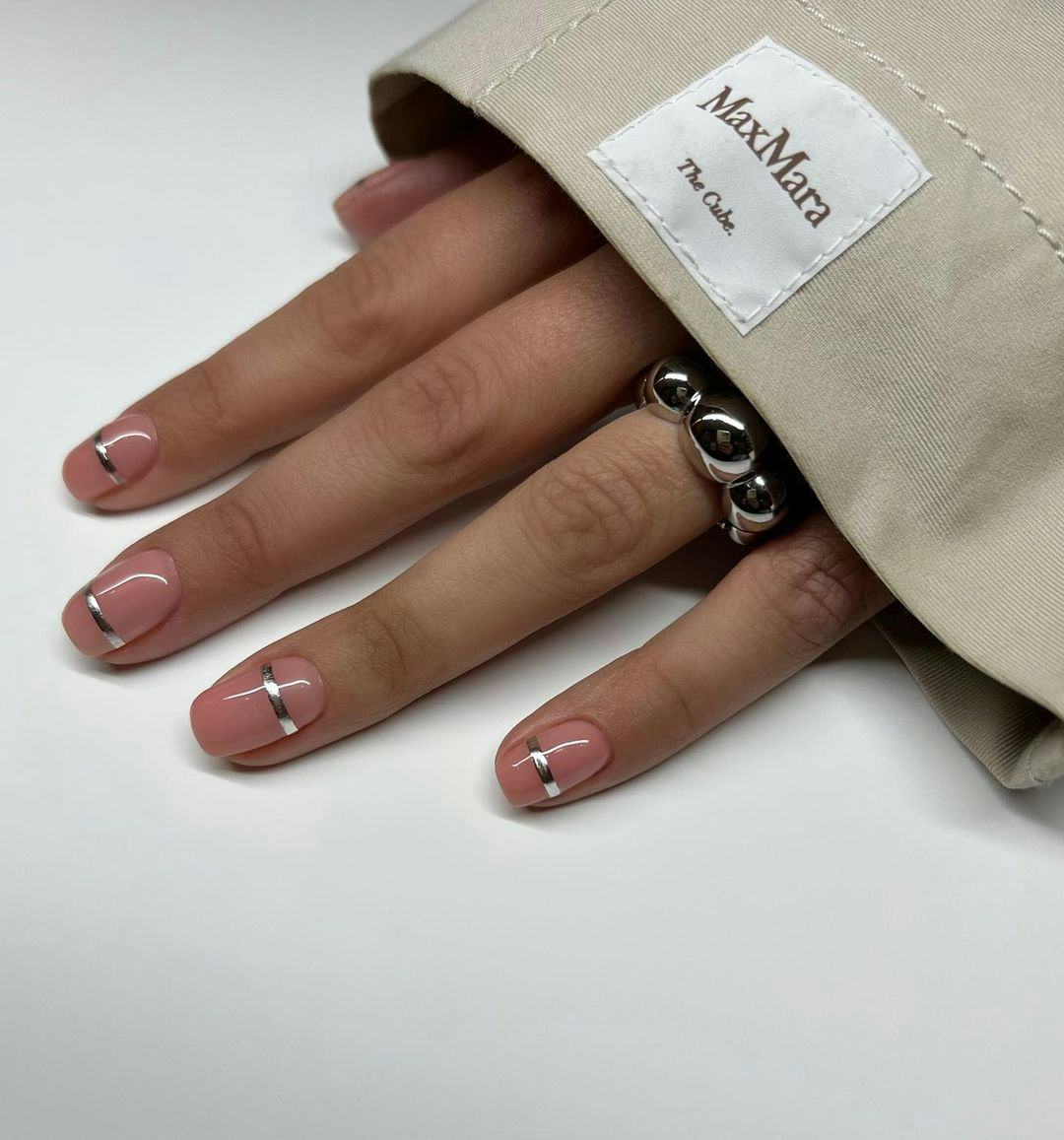 Minimal silver nail cuffs are on-trend for 2024&rsquo;s Aquarius season.
