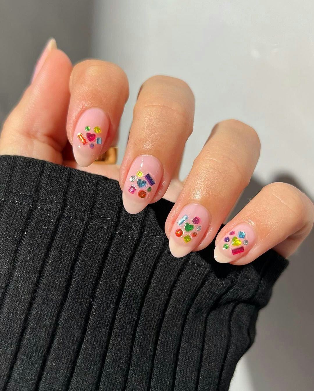 Lisa Frank-inspired colorful rhinestone nail adornments are on-trend for 2024&rsquo;s Aquarius season.
