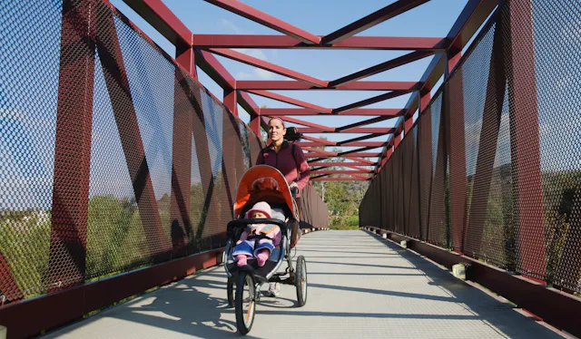 A mom goes on a run with her child in a stroller.