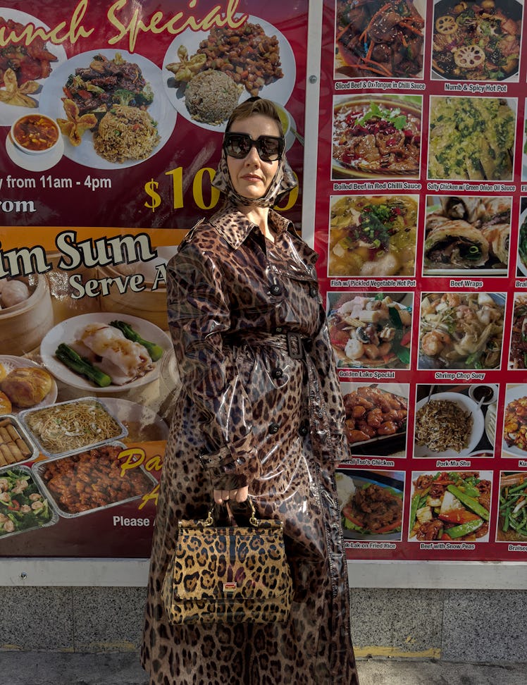 Hüller wears a Dolce & Gabbana trenchcoat, headscarf, sunglasses, and bag; Wolford tights.