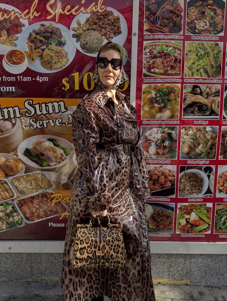 Hüller wears a Dolce & Gabbana trenchcoat, headscarf, sunglasses, and bag; Wolford tights.